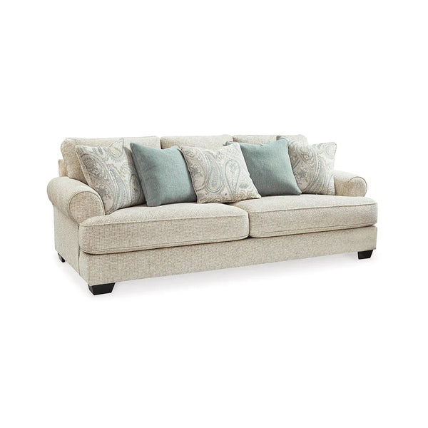 Accent pillows in spa mist and jacquard paisley complementing the sofa.