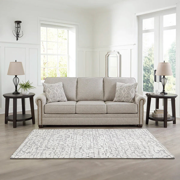 Transitional herringbone sofa with nailhead trim and bun legs – Ashley UAE.