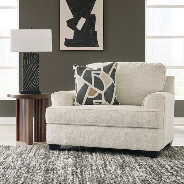 Oversized chair with clean lines, curved details, and neutral fabric upholstery