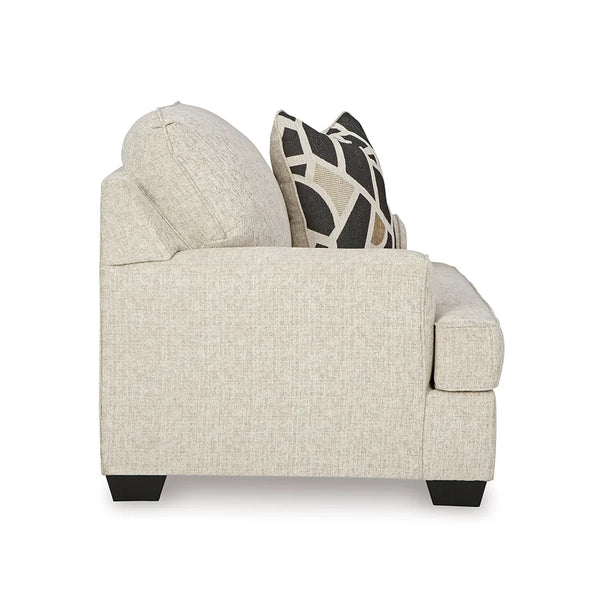 Close-up of plush seat and back cushions with accent pillow on oversized chair