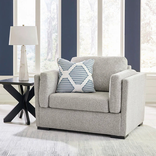 Oversized chair in fresh neutral hue with reversible cushions and bolster pillows