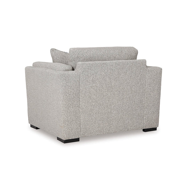 Side view of oversized chair with accent pillow and low-profile faux wood legs