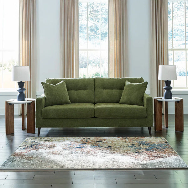 Mid-century modern sofa with tufted back cushions and tapered legs.