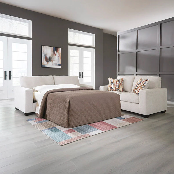 Aviemore queen sofa sleeper with light neutral upholstery and bold accent pillows