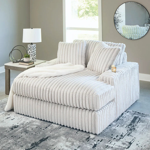 Stupendous oversized chaise with retro jumbo cord fabric, feather-blend cushions, cup holders, and built-in USB charging for modern lounging.